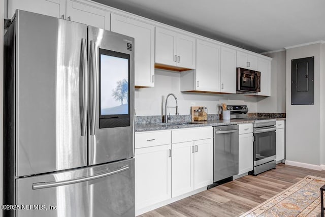 kitchen featuring sink, white cabinets, stainless steel appliances, crown molding, and light hardwood / wood-style flooring