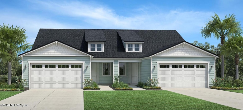 view of front of property with a garage and a front yard