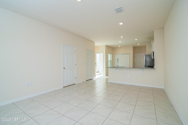 spare room featuring light tile patterned floors