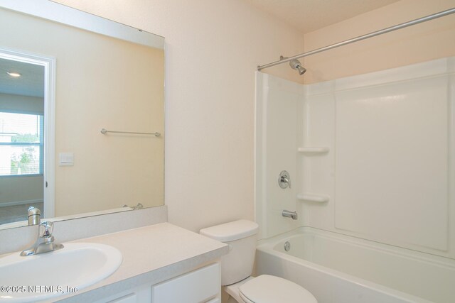 full bathroom with vanity, shower / bathtub combination, and toilet