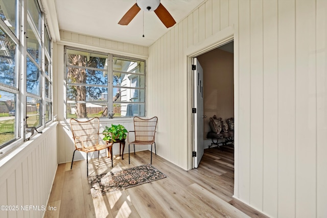 sunroom featuring a ceiling fan