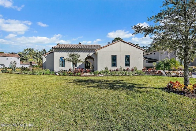 mediterranean / spanish-style house featuring a front lawn