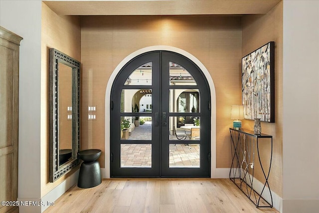 entryway with light hardwood / wood-style floors and french doors