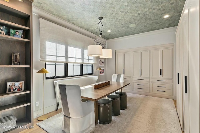 dining area with crown molding, built in features, and light hardwood / wood-style floors