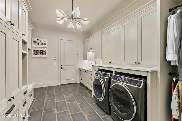 washroom featuring separate washer and dryer, sink, a chandelier, cabinets, and crown molding