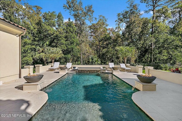 view of swimming pool featuring a patio and pool water feature