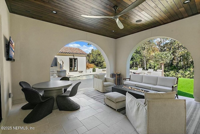 view of patio / terrace with ceiling fan and an outdoor living space