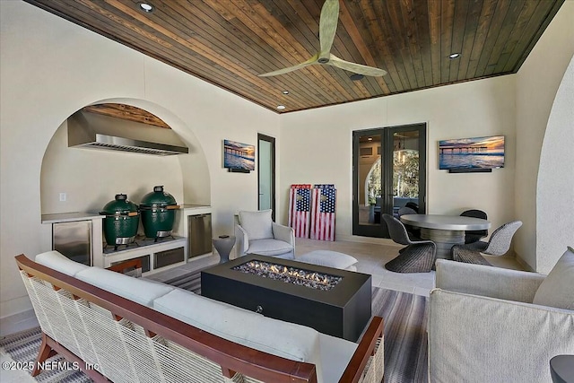 living room with french doors, ceiling fan, and wooden ceiling