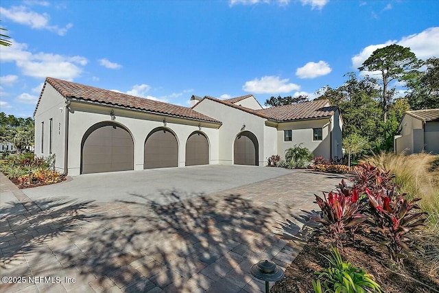 mediterranean / spanish home with a garage