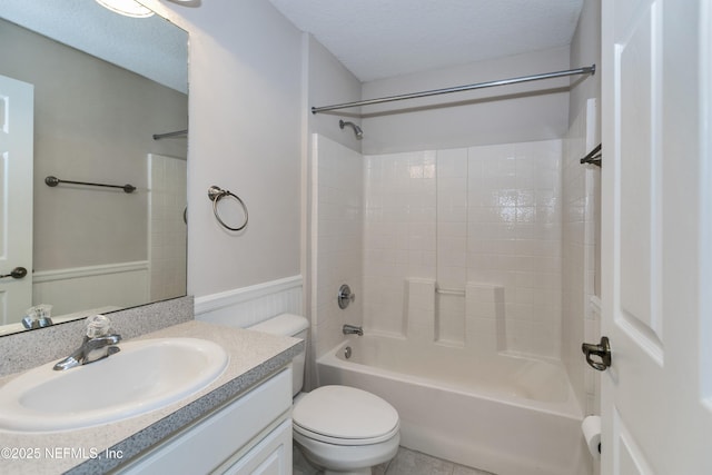 full bathroom with shower / tub combination, vanity, toilet, and a textured ceiling