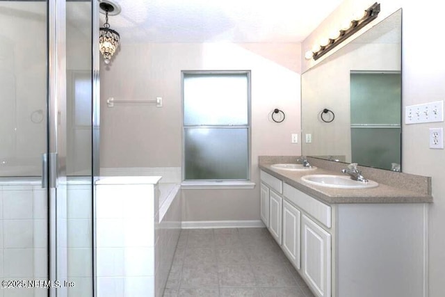 bathroom featuring tile patterned flooring, vanity, and a shower with door