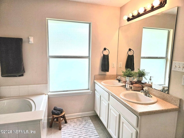 bathroom featuring vanity, tile patterned floors, and tiled bath