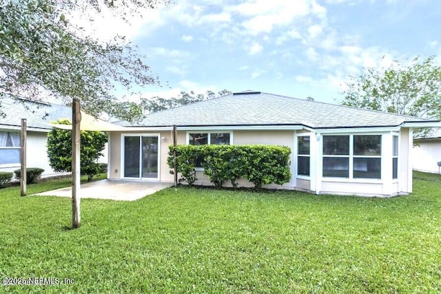 back of property featuring a patio and a lawn