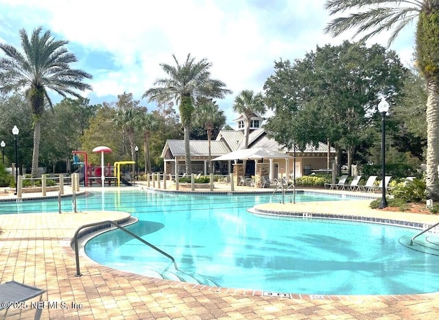 view of pool with a playground