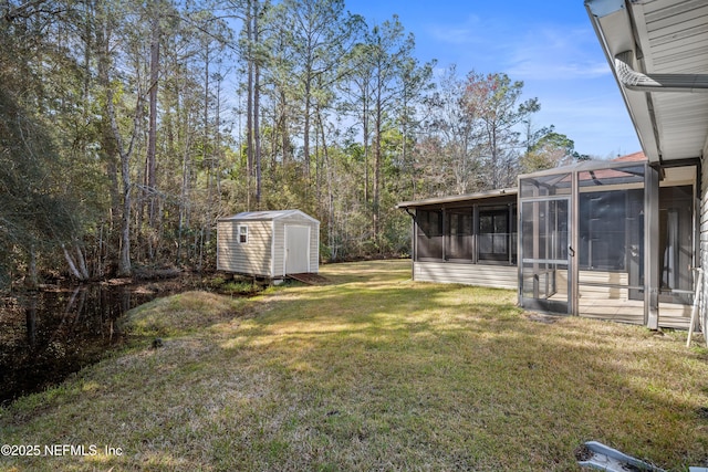 view of yard featuring a shed and a sunroom