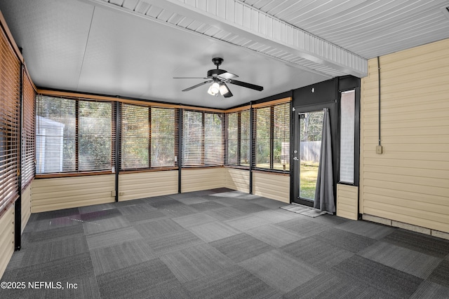 unfurnished sunroom with ceiling fan