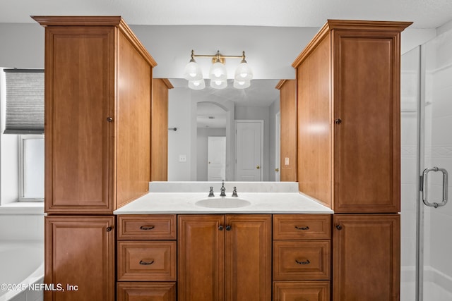 bathroom with vanity and separate shower and tub