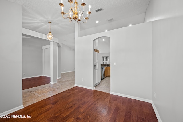 unfurnished room featuring a textured ceiling and light wood-type flooring