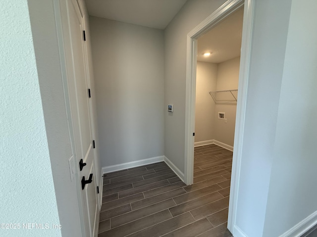 laundry room featuring baseboards, laundry area, washer hookup, and wood tiled floor