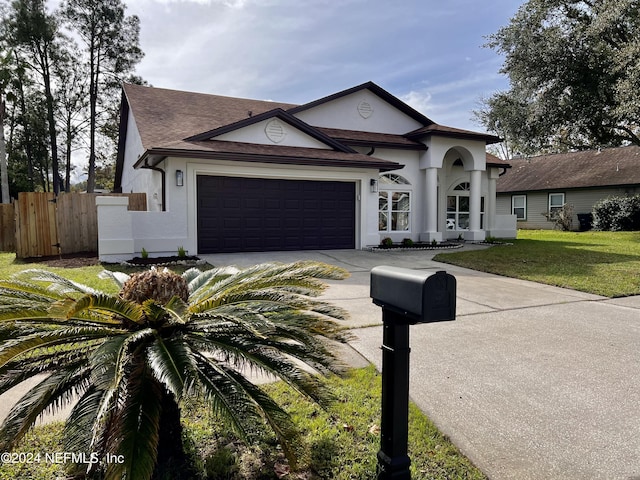 view of front of property featuring a garage and a front yard