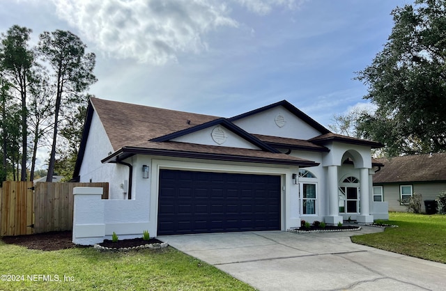 view of front of property featuring a garage and a front lawn