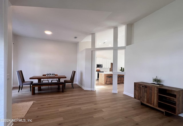 dining space with dark hardwood / wood-style flooring