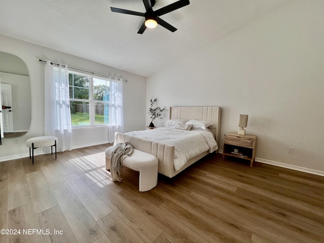 bedroom featuring lofted ceiling, hardwood / wood-style floors, and ceiling fan