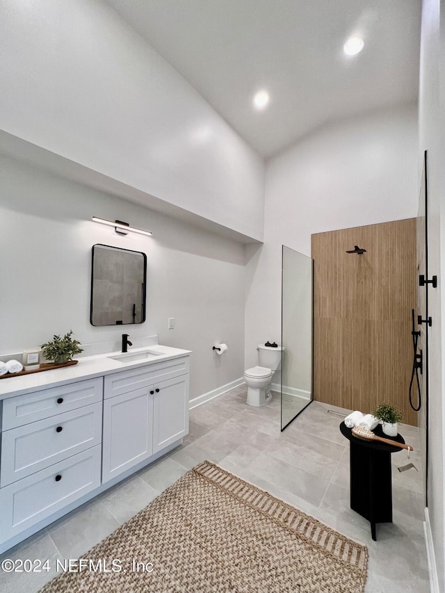 bathroom with tile patterned flooring, a towering ceiling, vanity, toilet, and walk in shower