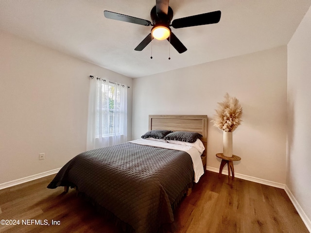 bedroom with ceiling fan and dark hardwood / wood-style floors