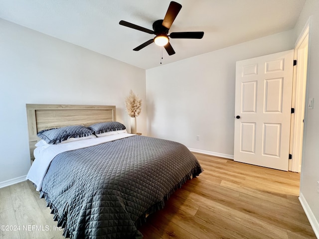 bedroom with hardwood / wood-style floors and ceiling fan