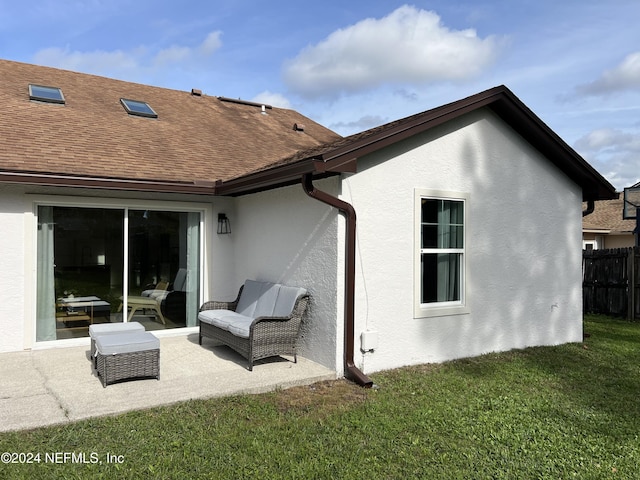 rear view of property featuring a lawn