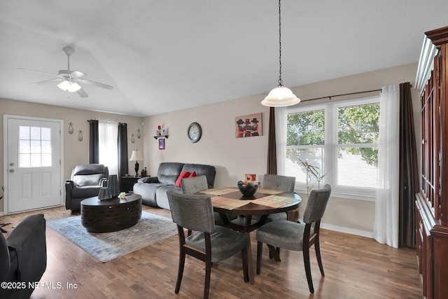 dining space featuring hardwood / wood-style flooring, ceiling fan, and lofted ceiling