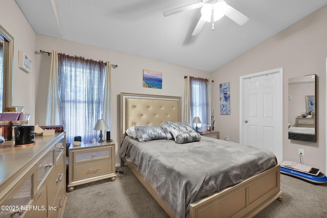 carpeted bedroom featuring ceiling fan, vaulted ceiling, and multiple windows