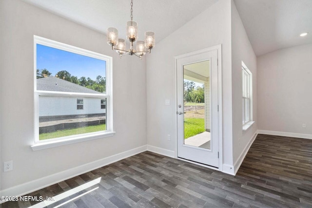 doorway featuring lofted ceiling, plenty of natural light, and dark hardwood / wood-style floors