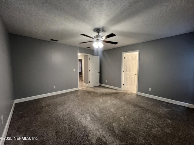 empty room with carpet floors, a textured ceiling, and ceiling fan