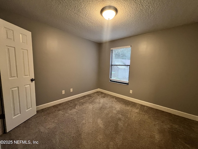 carpeted spare room with a textured ceiling