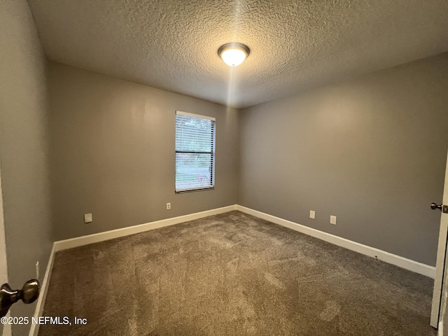 carpeted spare room with a textured ceiling