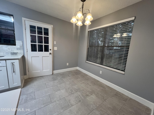 unfurnished dining area with a chandelier