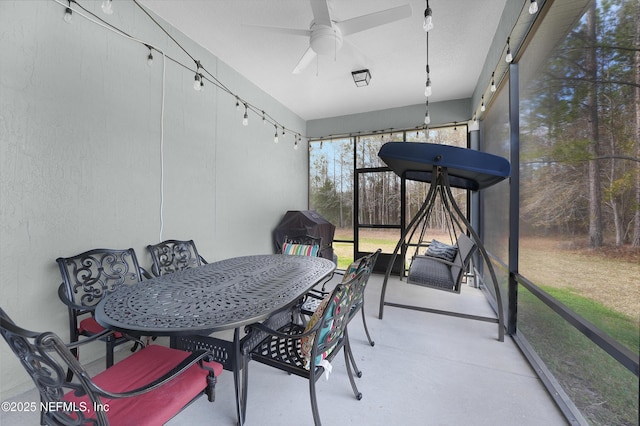 sunroom / solarium featuring ceiling fan