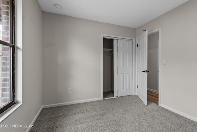 unfurnished bedroom with carpet floors and a closet