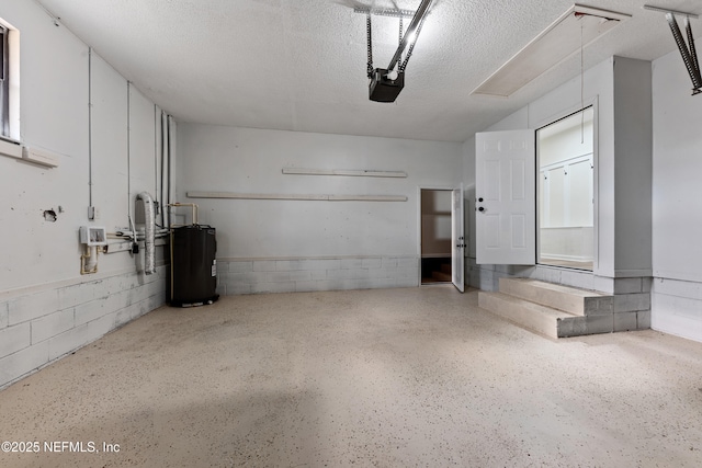 garage featuring a garage door opener and electric water heater