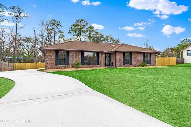 ranch-style home with a front lawn