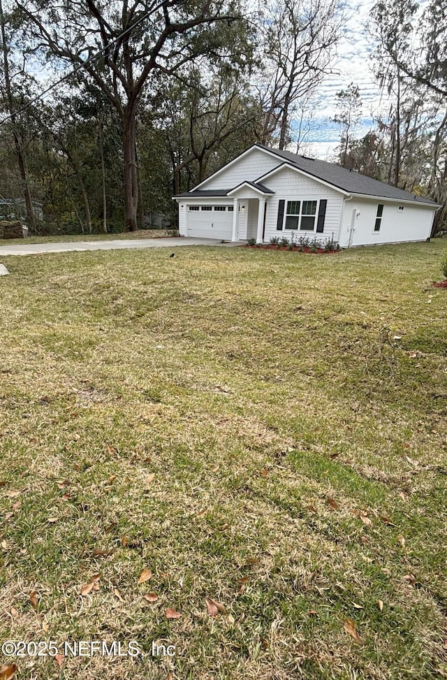 exterior space featuring a garage and a lawn