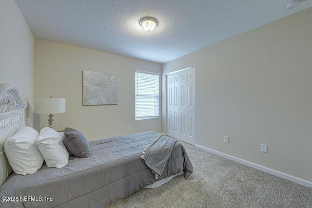 carpeted bedroom with a textured ceiling and a closet