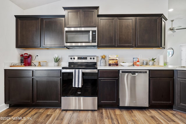 kitchen featuring dark brown cabinetry and appliances with stainless steel finishes