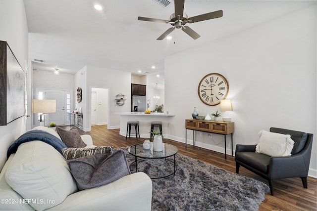 living room featuring ceiling fan and dark hardwood / wood-style flooring