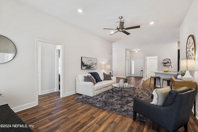 living room with dark wood-type flooring and ceiling fan