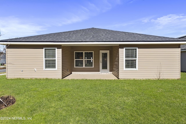 rear view of property with a patio and a yard