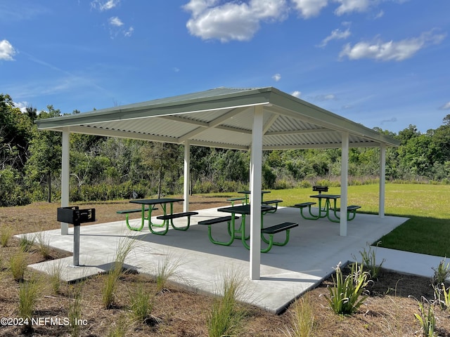 view of community featuring a gazebo, a patio area, and a lawn