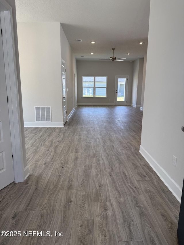 8284 Helmsley Blvd, Jacksonville, FL 32219 - unfurnished living room featuring visible vents, baseboards, wood finished floors, and a ceiling fan